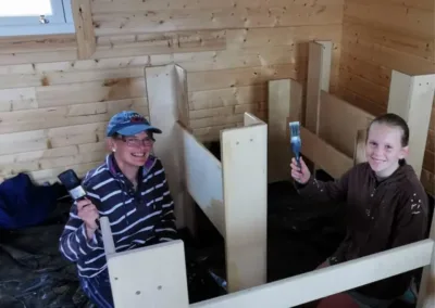 Volunteers varnishing beds