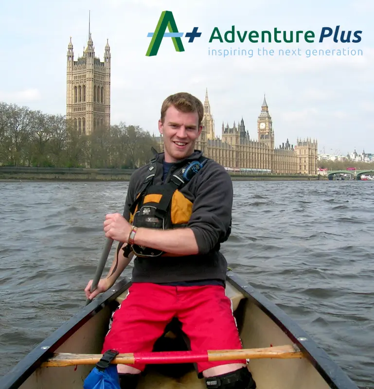Adult male in canoe with Big Ben in background