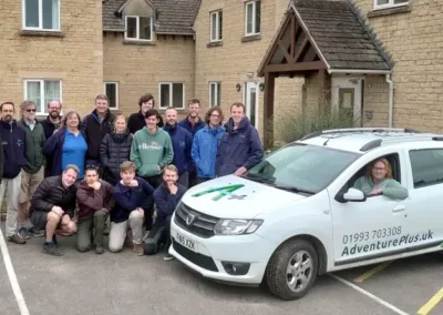 Group of people with company vehicle