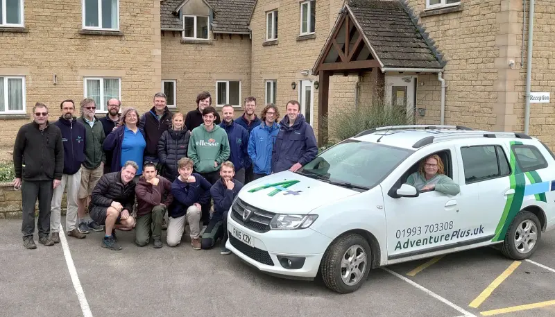 Group of people with company vehicle