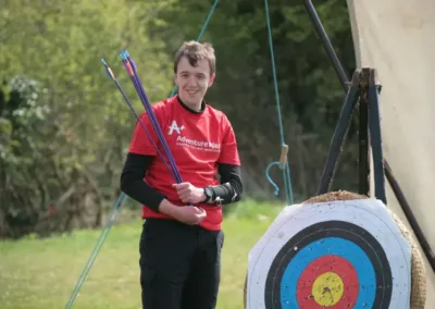 Man standing next to archery target