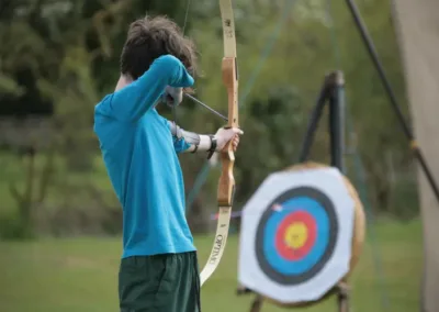 Child aiming at archery target