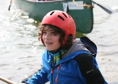 Child in red helmet in kayak