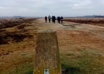Expedition group walking past a beacon