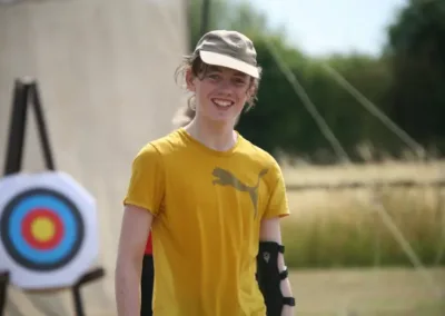 Teenager with archery target in background