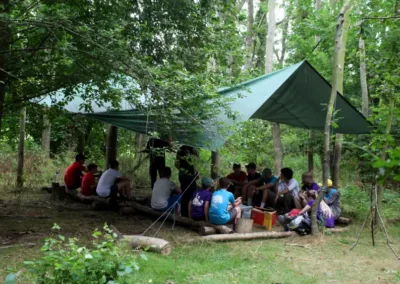 Children in a bushcraft shelter