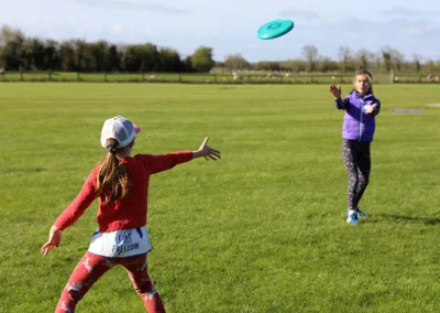 Children playing Frisbee on a playing field