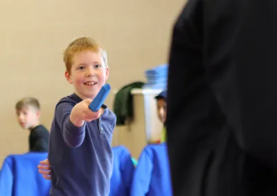 Smiling child practicing fencing