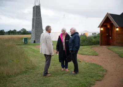 People chatting in front of climbing wall