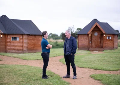 Gentlemen chatting outside newly built yurts