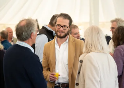 Group of people chatting in a marquee