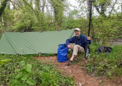 Man and his wild camping set up on the bank of the Dordogne River in France